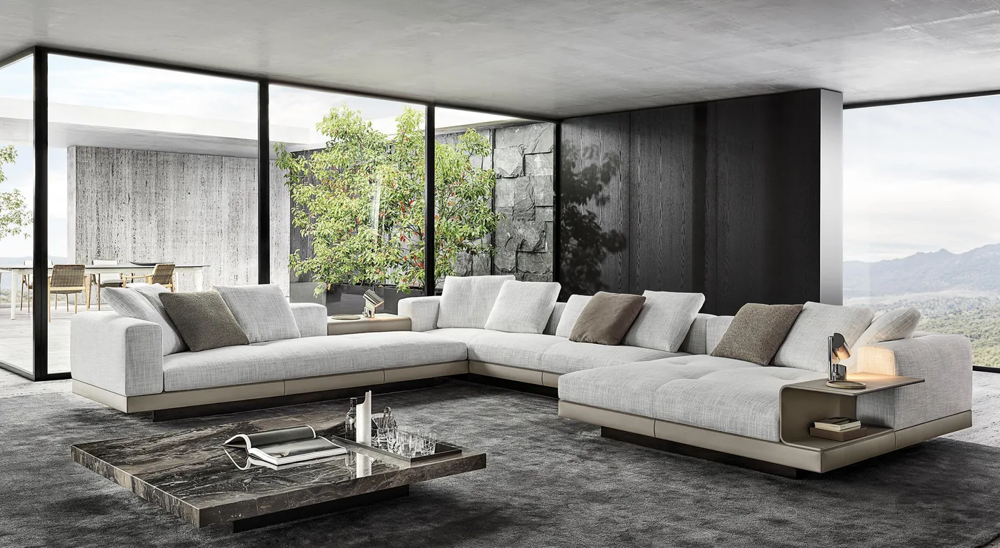 A light sectional sofa with broad upholstered seats and a low side unit in a contemporary living room.