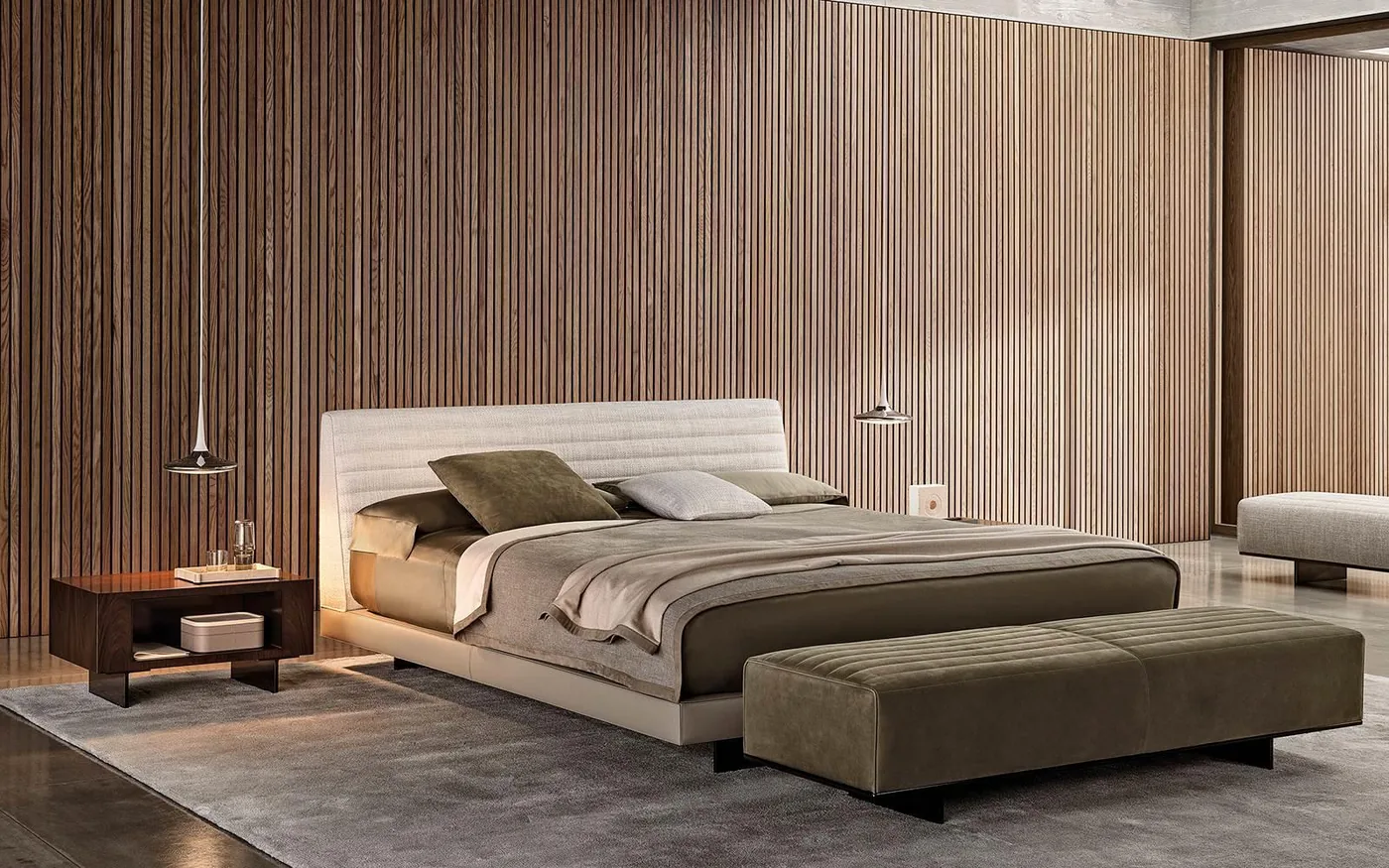 An upholstered bed and bedside pieces set against vertical timber wall panels.